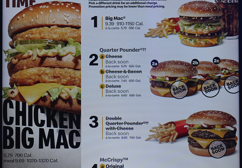 The electronic menu order board still displays Quarter Pounder hamburgers but with a prompt to tell consumers they will be available soon at a McDonald's drive-thru Wednesday, Oct. 23, 2024, in Littleton, Colo.