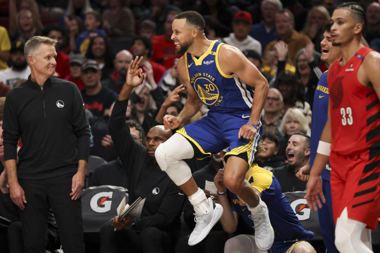 Golden State Warriors guard Stephen Curry (30) reacts after scoring a basket against the Portland Trail Blazers during the second half of an NBA basketball game Wednesday, Oct. 23, 2024, in Portland, Ore.