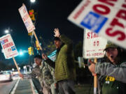 Boeing employees, including assembler Tyrone Hipolito, center, work the picket line after union members voted to reject a new contract offer from the company, Wednesday, Oct. 23, 2024, in Renton, Wash.