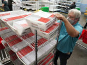 FILE - An election worker sorts mail-in ballots at the Multnomah County Duniway-Lovejoy Elections Building Monday, Nov. 2, 2020, in Portland, Ore.