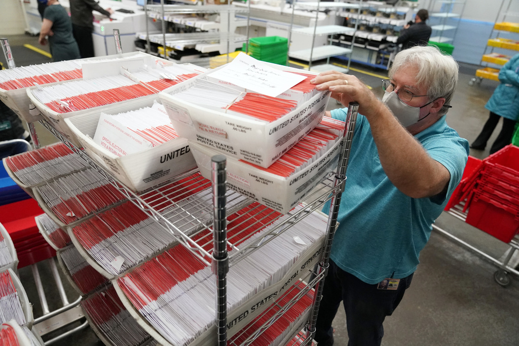 FILE - An election worker sorts mail-in ballots at the Multnomah County Duniway-Lovejoy Elections Building Monday, Nov. 2, 2020, in Portland, Ore.