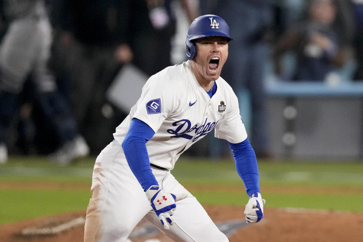 Los Angeles Dodgers' Freddie Freeman celebrates after hitting a walk-off grand slam home run during the 10th inning in Game 1 of the baseball World Series against the New York Yankees, Friday, Oct. 25, 2024, in Los Angeles. (AP Photo/Mark J.