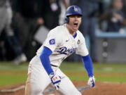 Los Angeles Dodgers' Freddie Freeman celebrates after hitting a walk-off grand slam home run during the 10th inning in Game 1 of the baseball World Series against the New York Yankees, Friday, Oct. 25, 2024, in Los Angeles. (AP Photo/Mark J.