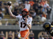 Oregon State quarterback Ben Gulbranson (17) looks to throw as California linebacker Liam Johnson (15) moves in during the second half of an NCAA college football game in Berkeley, Calif., Saturday, Oct. 26, 2024.