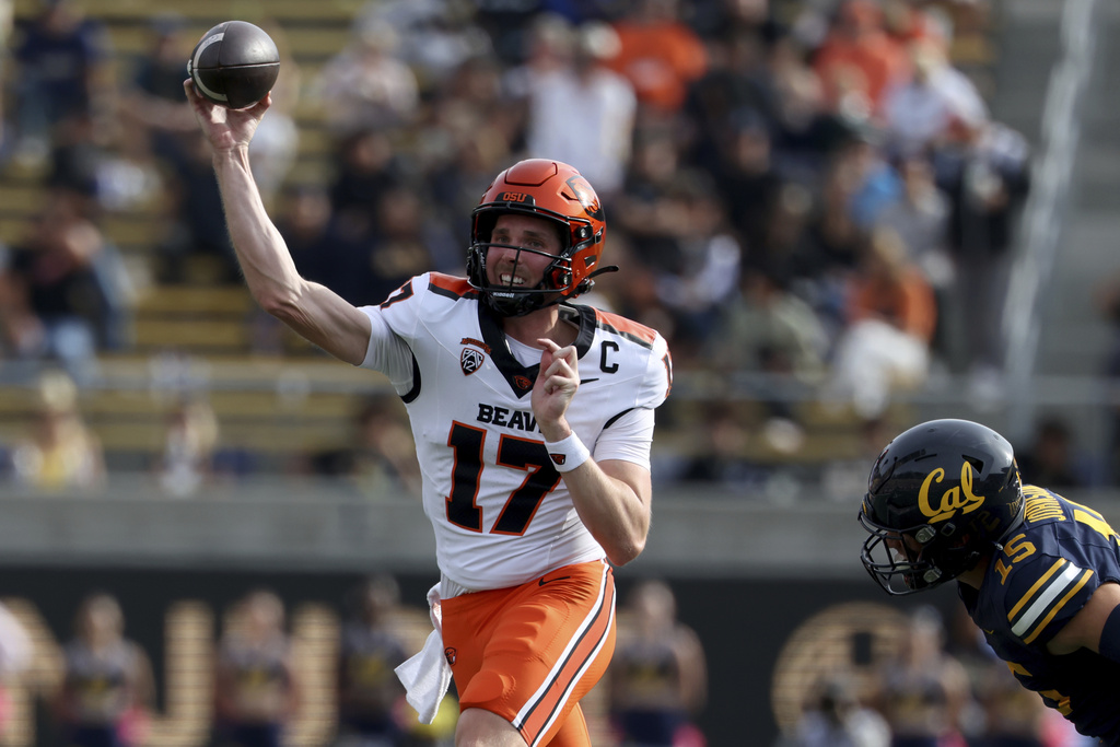 Oregon State quarterback Ben Gulbranson (17) looks to throw as California linebacker Liam Johnson (15) moves in during the second half of an NCAA college football game in Berkeley, Calif., Saturday, Oct. 26, 2024.