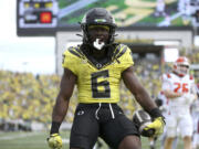 Oregon running back Noah Whittington celebrates his touchdown during an NCAA college football game against Illinois, Saturday, Oct. 26, 2024, in Eugene, Ore.