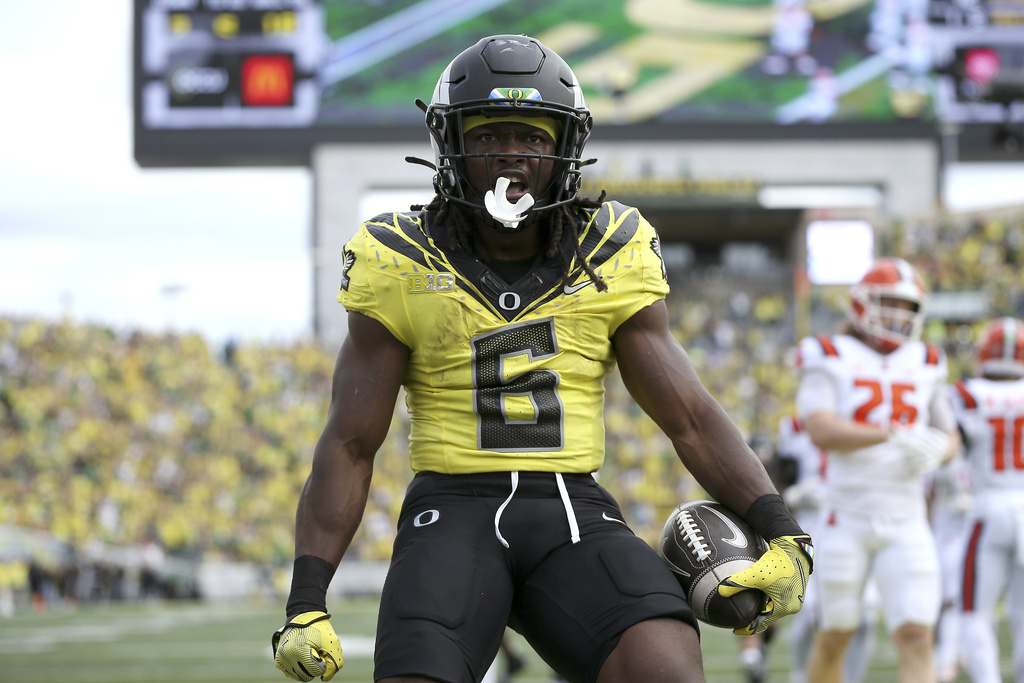 Oregon running back Noah Whittington celebrates his touchdown during an NCAA college football game against Illinois, Saturday, Oct. 26, 2024, in Eugene, Ore.