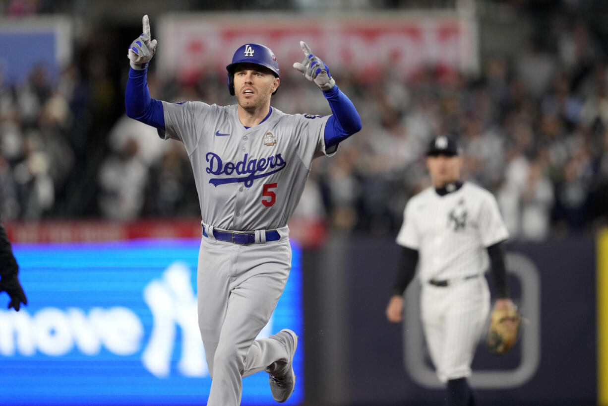 Los Angeles Dodgers' Freddie Freeman celebrates a two-run home run against the New York Yankees during the first inning in Game 3 of the baseball World Series, Monday, Oct. 28, 2024, in New York.