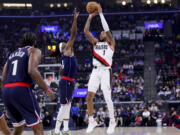 Portland Trail Blazers guard Anfernee Simons (1) shoots against Los Angeles Clippers guard Terance Mann (14) during the first half of an NBA basketball game, Wednesday, Oct. 30, 2024, in Inglewood, Calif.