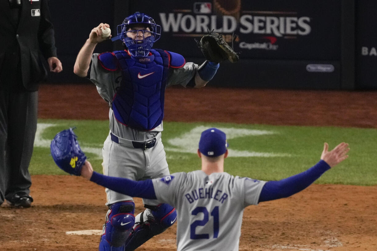 Los Angeles Dodgers pitcher Walker Buehler and catcher Will Smith celebrate their win against the New York Yankees in Game 5 to win the baseball World Series, Wednesday, Oct. 30, 2024, in New York.