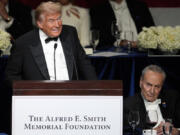 Republican presidential nominee former President Donald Trump speaks as Senate Majority Leader Chuck Schumer of N.Y., listens at the 79th annual Alfred E. Smith Memorial Foundation Dinner, Thursday, Oct. 17, 2024, in New York.