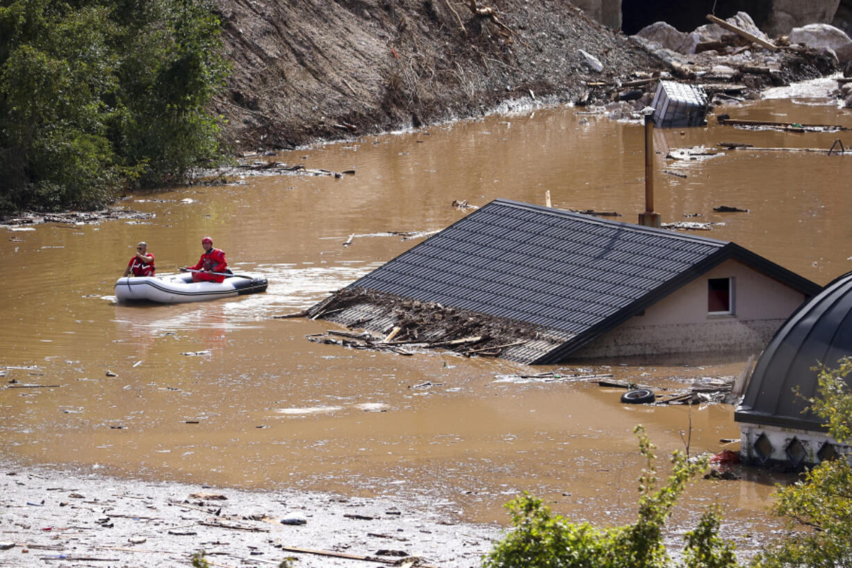 Search and rescue teams look for people in the flooded houses in Jablanica, Bosnia, Friday, Oct. 4, 2024.