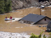 Search and rescue teams look for people in the flooded houses in Jablanica, Bosnia, Friday, Oct. 4, 2024.