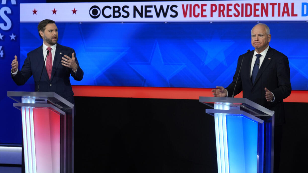 Republican vice presidential nominee Sen. JD Vance, R-Ohio, and Democratic vice presidential candidate Minnesota Gov. Tim Walz speak at the same time during a vice presidential debate hosted by CBS News, Tuesday, Oct. 1, 2024, in New York.