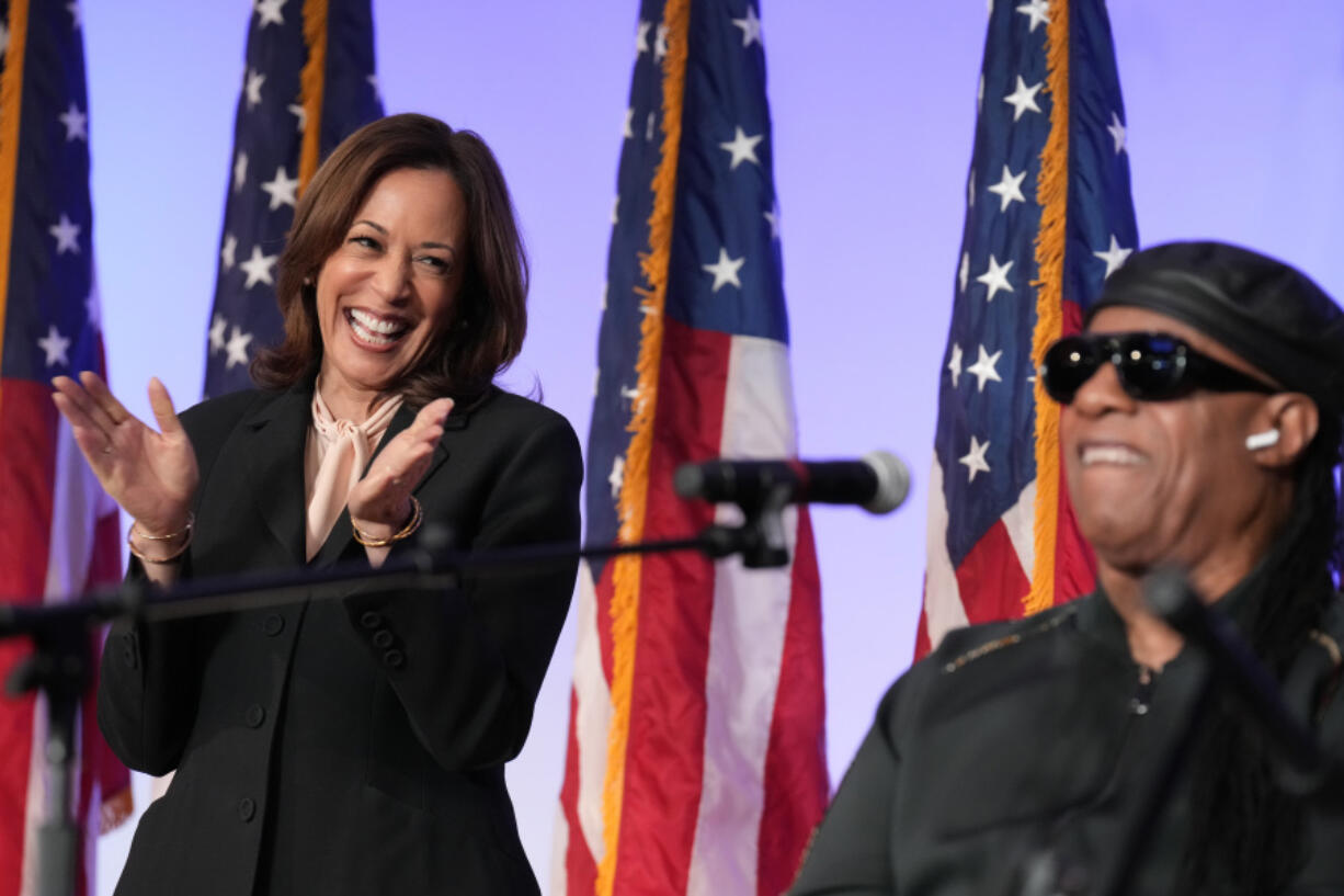 Democratic presidential nominee Vice President Kamala Harris listens as Stevie Wonder performs &ldquo;Redemption Song&rdquo; during a church service and early vote event at Divine Faith Ministries International, Sunday, Oct. 20, 2024, in Jonesboro, Ga.