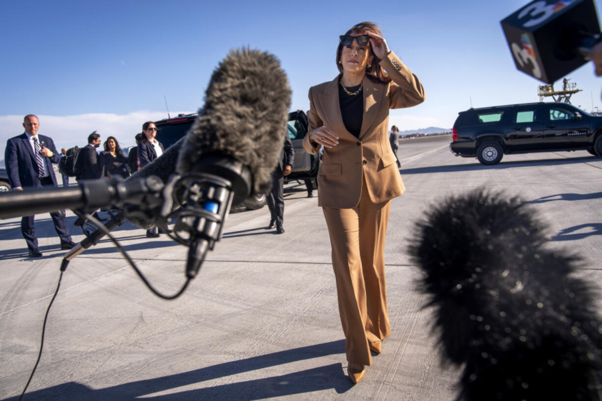 Democratic presidential nominee Vice President Kamala Harris walks toward reporters to speak before boarding Air Force Two, as she departs Las Vegas from Harry Reid International Airport, Thursday, Oct. 10, 2024, en route to Arizona.