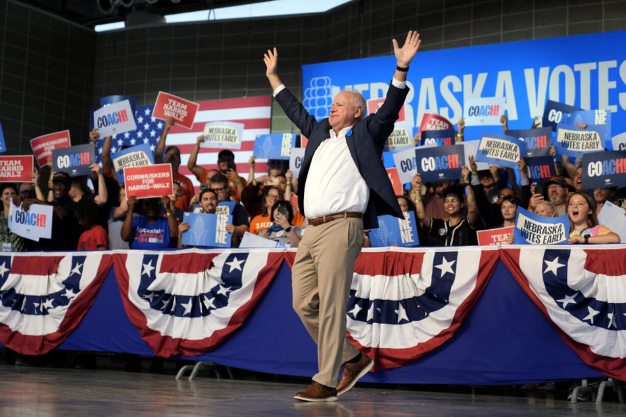 Democratic vice presidential nominee Minnesota Gov. Tim Walz reacts to supporters during a campaign rally, Saturday, Oct. 19, 2024, in Papillion, Neb.