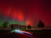 An aurora borealis, also known as the northern lights, glows in the night sky above a road in Lietzen, eastern Germany.