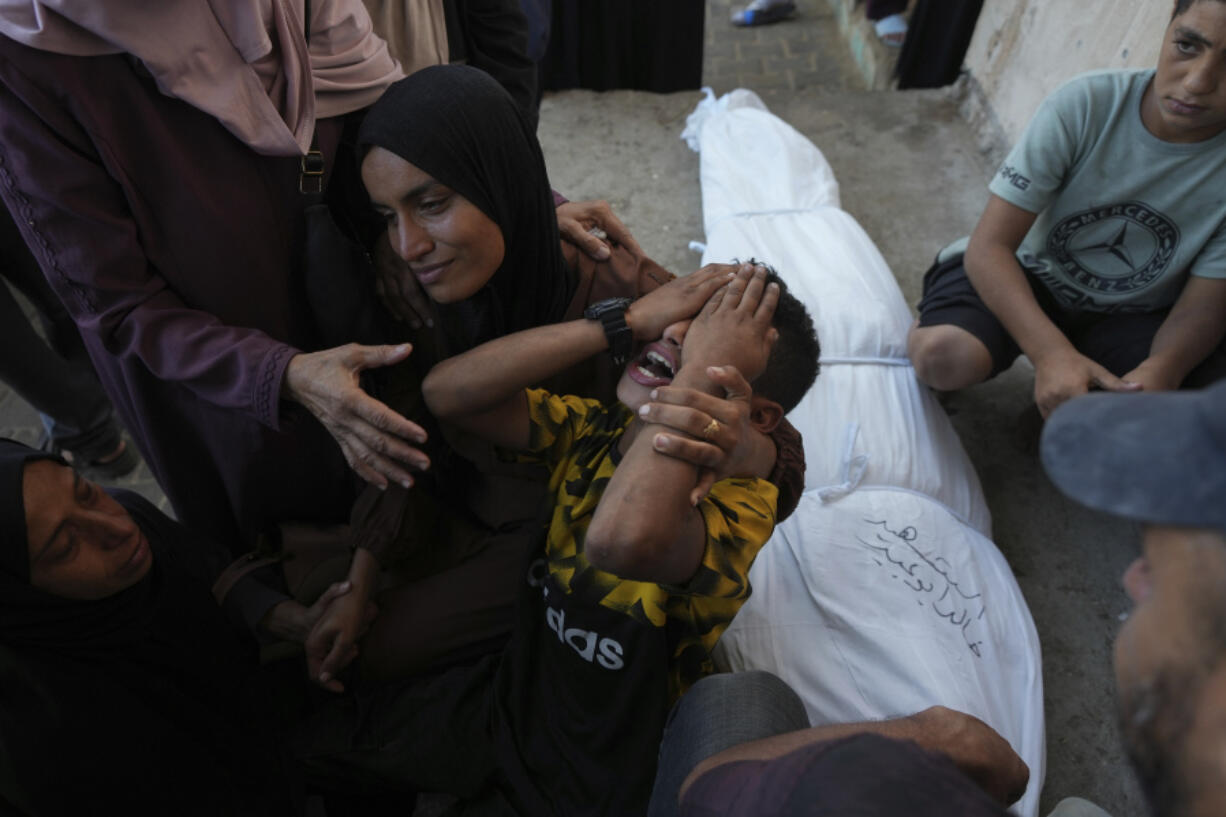 Mourners attend the funeral of Palestinians killed in the Israeli bombardment of the Gaza Strip outside the hospital morgue in Deir al-Balah on Wednesday, Oct. 9, 2024.