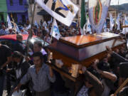 People carry the coffin of Catholic priest Marcelo Perez, who was killed in San Cristobal de las Casas, Chiapas state, Mexico, Sunday, Oct. 20, 2024.