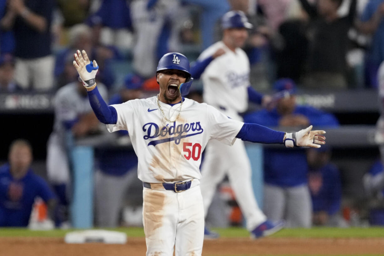 Los Angeles Dodgers&#039; Mookie Betts celebrates a RBI-double against the New York Mets during the eighth inning in Game 6 of a baseball NL Championship Series, Sunday, Oct. 20, 2024, in Los Angeles. (AP Photo/Mark J.