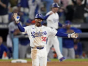 Los Angeles Dodgers&#039; Mookie Betts celebrates a RBI-double against the New York Mets during the eighth inning in Game 6 of a baseball NL Championship Series, Sunday, Oct. 20, 2024, in Los Angeles. (AP Photo/Mark J.