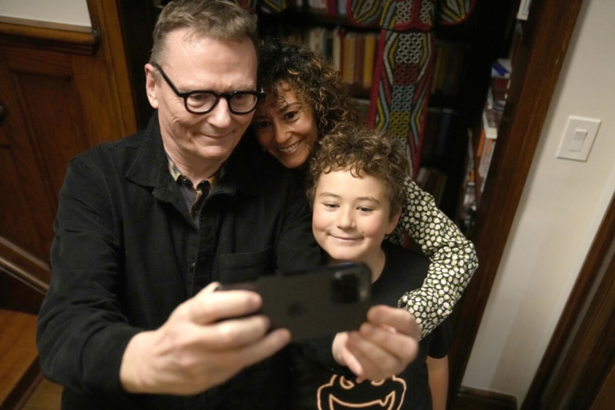 Nobel prize winner in Economics, James A. Robinson makes a selfie for the Nobel Foundation with his wife, Dr. Maria Angelica Bautista, and their son Adrian at their home in the Hyde Park neighborhood of Chicago, Monday, Oct. 14, 2024.