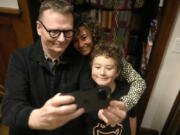 Nobel prize winner in Economics, James A. Robinson makes a selfie for the Nobel Foundation with his wife, Dr. Maria Angelica Bautista, and their son Adrian at their home in the Hyde Park neighborhood of Chicago, Monday, Oct. 14, 2024.