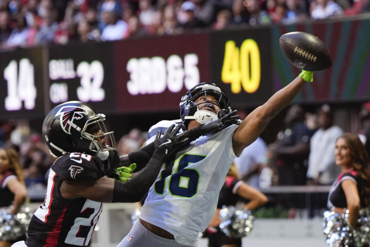 Atlanta Falcons cornerback Dee Alford (20) breaks up a pass intended for Seattle Seahawks wide receiver Tyler Lockett (16) during the second half of an NFL football game, Sunday, Oct. 20, 2024, in Atlanta.