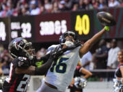 Atlanta Falcons cornerback Dee Alford (20) breaks up a pass intended for Seattle Seahawks wide receiver Tyler Lockett (16) during the second half of an NFL football game, Sunday, Oct. 20, 2024, in Atlanta.