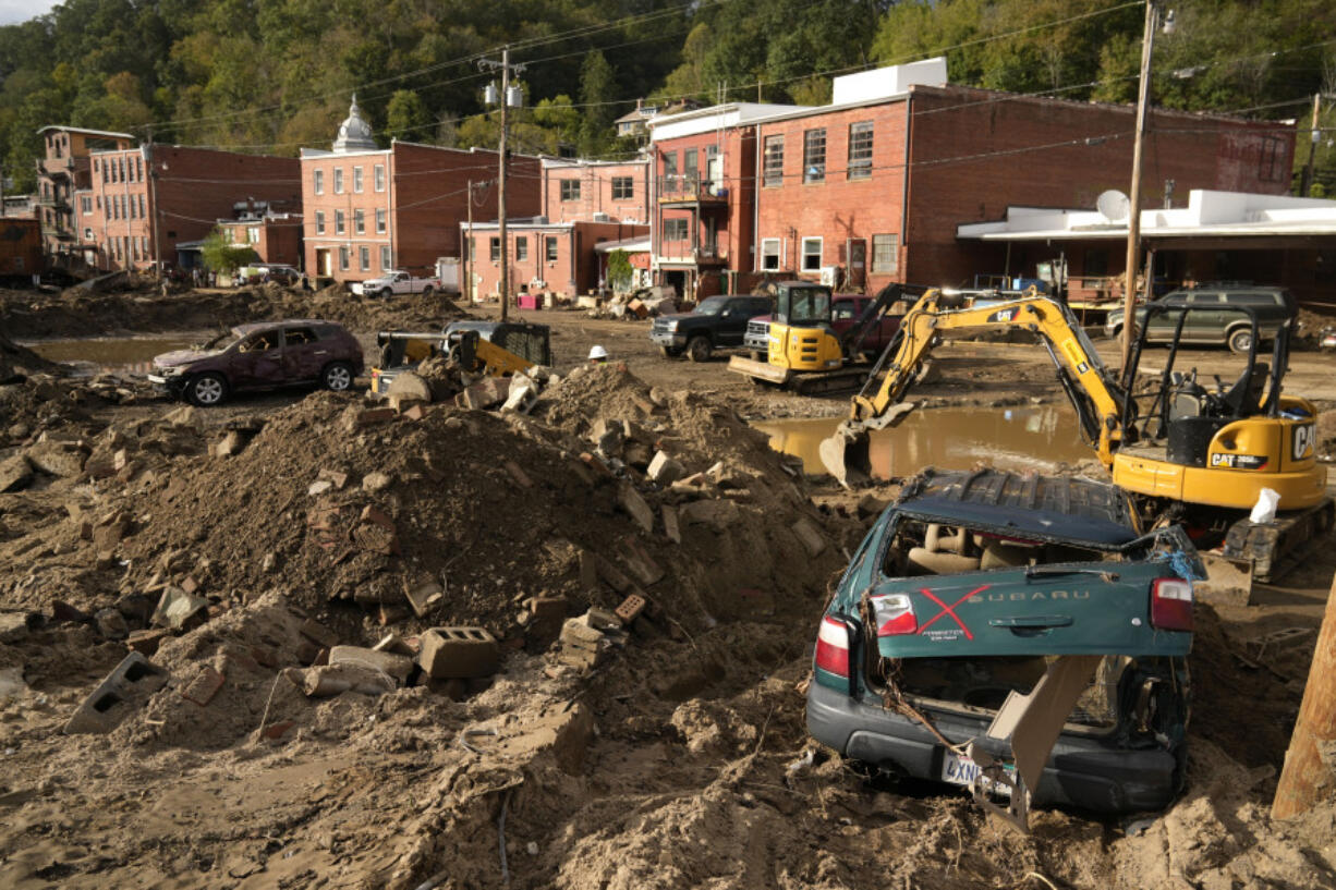 Debris left in the aftermath of Hurricane Helene fills the street Tuesday, Oct. 1, 2024, in Marshall, N.C.