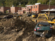 Debris left in the aftermath of Hurricane Helene fills the street Tuesday, Oct. 1, 2024, in Marshall, N.C.