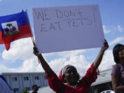 Wilda Brooks of West Palm Beach, Fla., holds up a sign reading &ldquo;We don&rsquo;t eat pets,&rdquo; during a rally by members of South Florida&rsquo;s Haitian-American community to condemn hate speech and misinformation about Haitian immigrants, Sunday, Sept. 22, 2024, in North Miami, Fla.