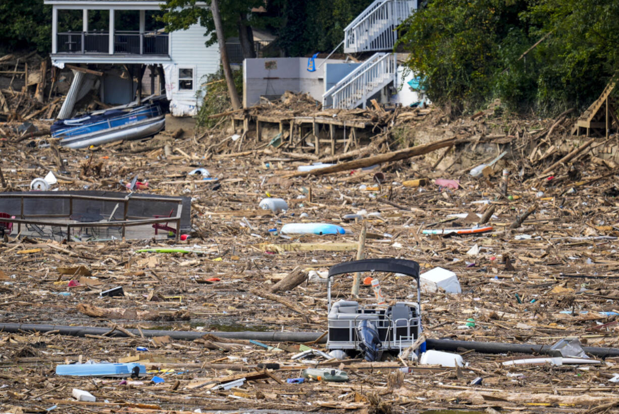 Debris is strewn on the lake in the aftermath of Hurricane Helene, Wednesday, Oct. 2, 2024, in Lake Lure, N.C.