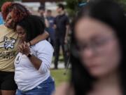 Mourners pray during a candlelight vigil for the slain students and teachers at Apalachee High School, Wednesday, Sept. 4, 2024, in Winder, Ga.