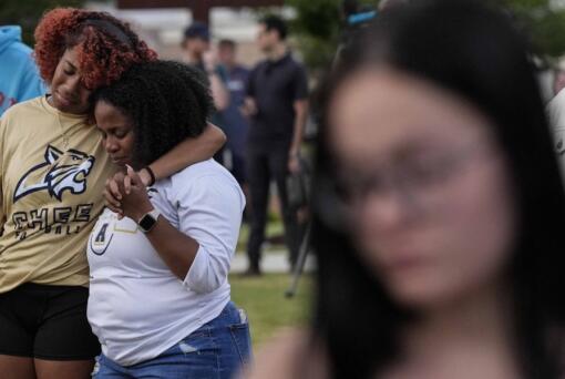 Mourners pray during a candlelight vigil for the slain students and teachers at Apalachee High School, Wednesday, Sept. 4, 2024, in Winder, Ga.