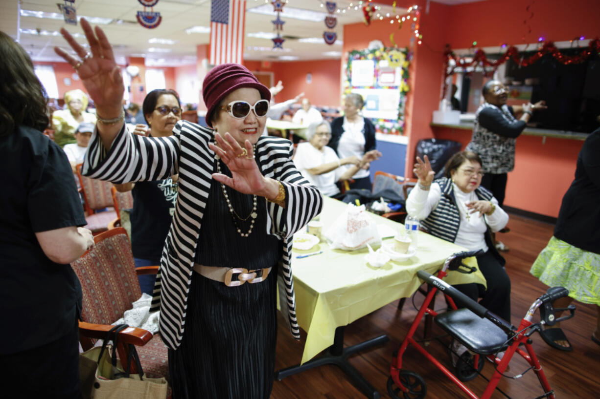 People attend a Zumba exercise class at Sunshine Adult Day Center in Bergenfield, N.J., Monday, Aug. 26, 2024.