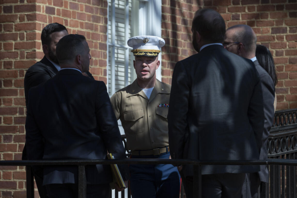 FILE - U.S. Marine Corp Major Joshua Mast, center, talks with his attorneys during a break in a hearing in an ongoing custody battle over an Afghan orphan, at the Circuit Courthouse in Charlottesville, Va., March 30, 2023.