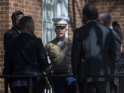 FILE - U.S. Marine Corp Major Joshua Mast, center, talks with his attorneys during a break in a hearing in an ongoing custody battle over an Afghan orphan, at the Circuit Courthouse in Charlottesville, Va., March 30, 2023.