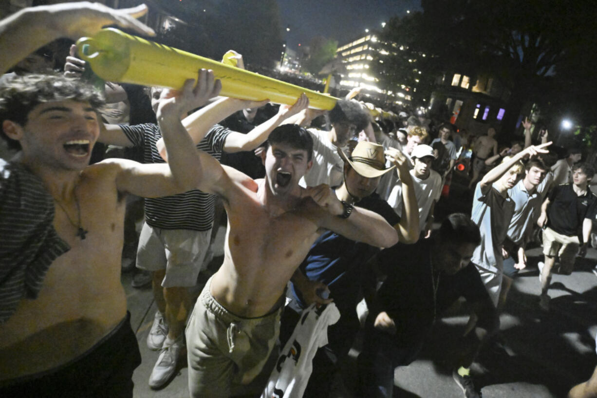 Vanderbilt fans celebrate as they carry the goalpost down West End Avenue after defeating Alabama in an NCAA football game on Saturday, Oct. 5, 2024, in Nashville, Tenn.