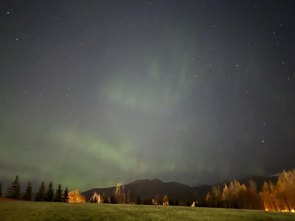 The northern lights appear over the Chugach Mountains in east Anchorage, Alaska, Wednesday, Oct. 2, 2024.