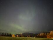 The northern lights appear over the Chugach Mountains in east Anchorage, Alaska, Wednesday, Oct. 2, 2024.