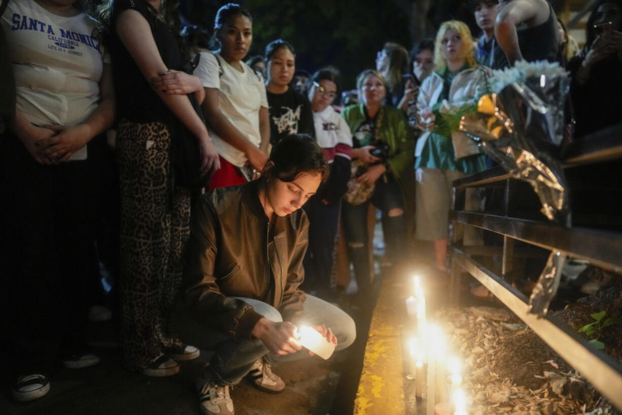 Fans light candles outside the hotel where former One Direction singer Liam Payne was found dead after he fell from a balcony in Buenos Aires, Argentina, Wednesday, Oct. 16, 2024.