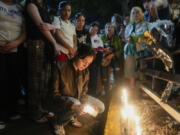 Fans light candles outside the hotel where former One Direction singer Liam Payne was found dead after he fell from a balcony in Buenos Aires, Argentina, Wednesday, Oct. 16, 2024.