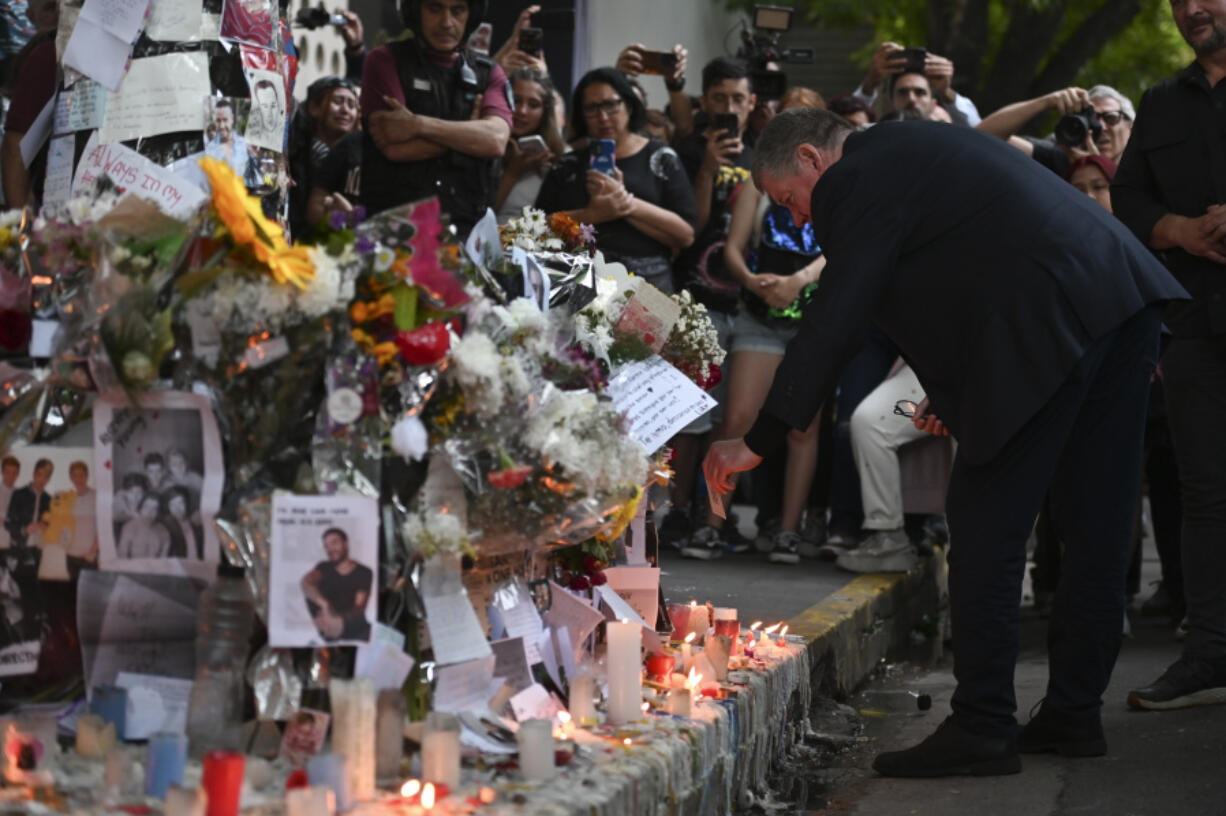 Geoff Payne, right, the father of former One Direction singer Liam Payne, visits a memorial outside the Casa Sur Hotel where the British pop singer fell to his death from a hotel balcony, in Buenos Aires, Argentina, Friday, Oct. 18, 2024.