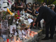 Geoff Payne, right, the father of former One Direction singer Liam Payne, visits a memorial outside the Casa Sur Hotel where the British pop singer fell to his death from a hotel balcony, in Buenos Aires, Argentina, Friday, Oct. 18, 2024.