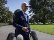 President Joe Biden speaks to the media before boarding Marine One on the South Lawn of the White House in Washington, Saturday, Oct. 5, 2024.