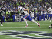 Buffalo Bills tight end Dalton Kincaid (86) scores a touchdown during the first half of an NFL football game against the Seattle Seahawks, Sunday, Oct. 27, 2024, in Seattle.