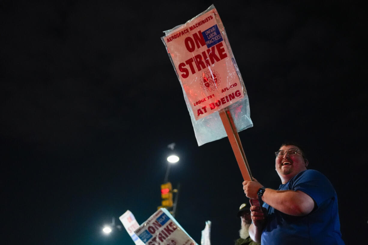 Machinist AJ Nelson, who has worked for Boeing for six years, works the picket line after union members voted to reject a new contract offer from the company, Wednesday, Oct. 23, 2024, in Renton, Wash.