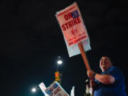 Machinist AJ Nelson, who has worked for Boeing for six years, works the picket line after union members voted to reject a new contract offer from the company, Wednesday, Oct. 23, 2024, in Renton, Wash.